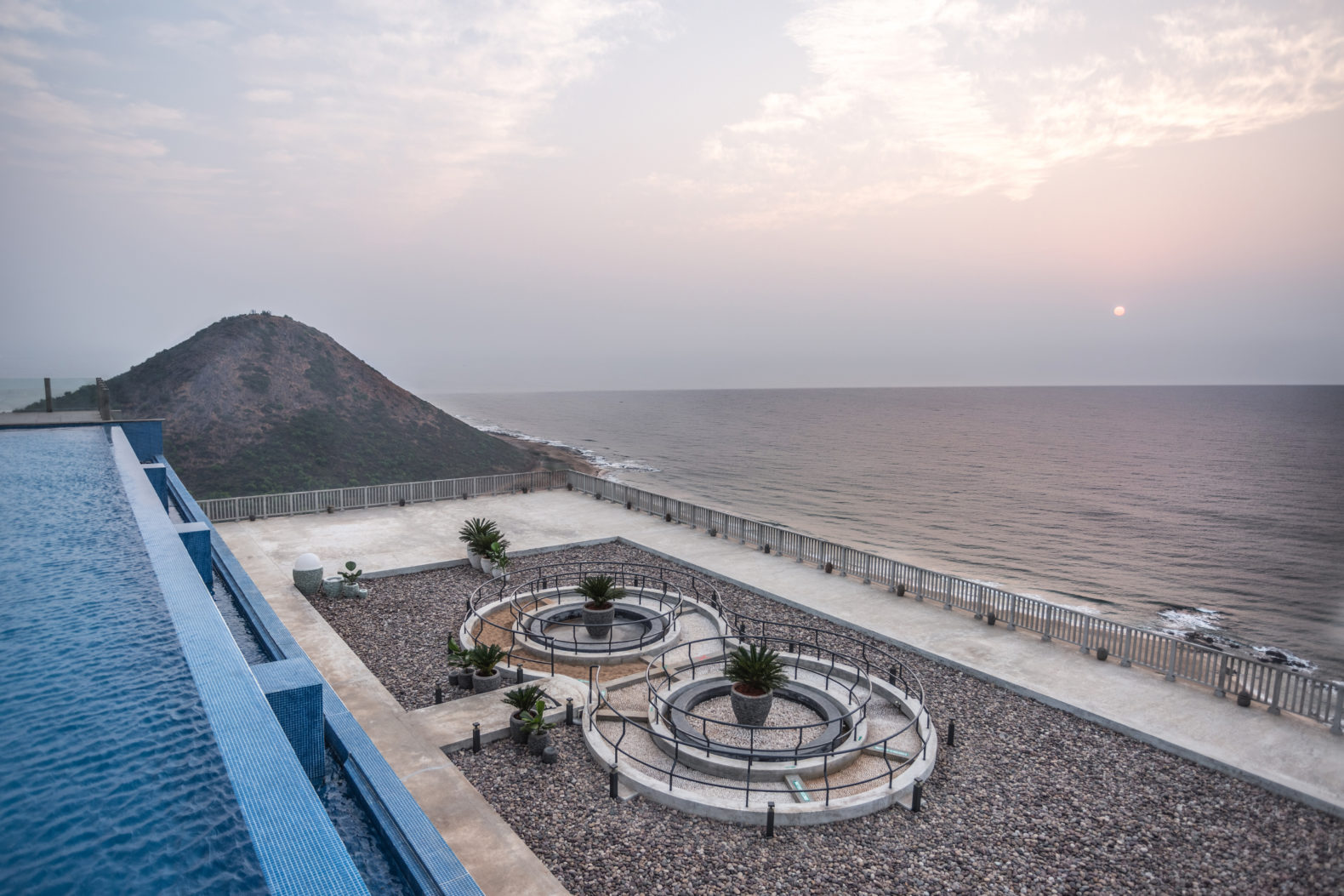 garden-view-natural-stones-infinity-pool-ocean-waves-moonshine-pema-health-healing-resort-india-hotel