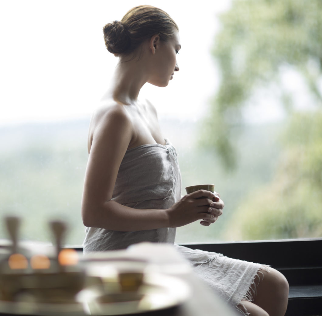 weightloss-TVC_Ayurveda_Vivanta By Taj - Madikeri, Coorg India_woman with healing drink and bathing robe sitting to enjoy panoramic view-travel-to-heal
