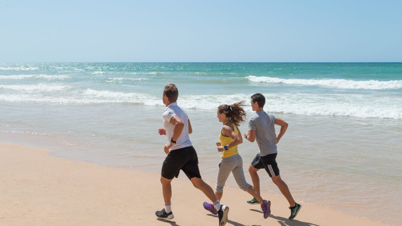 people-running-beach-sports-activity-ocean-white-sand-pine-cliff-resort-algarve-portugal